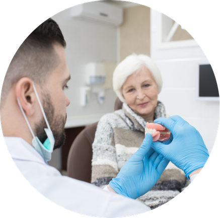 A dentist showing Dentures to patient