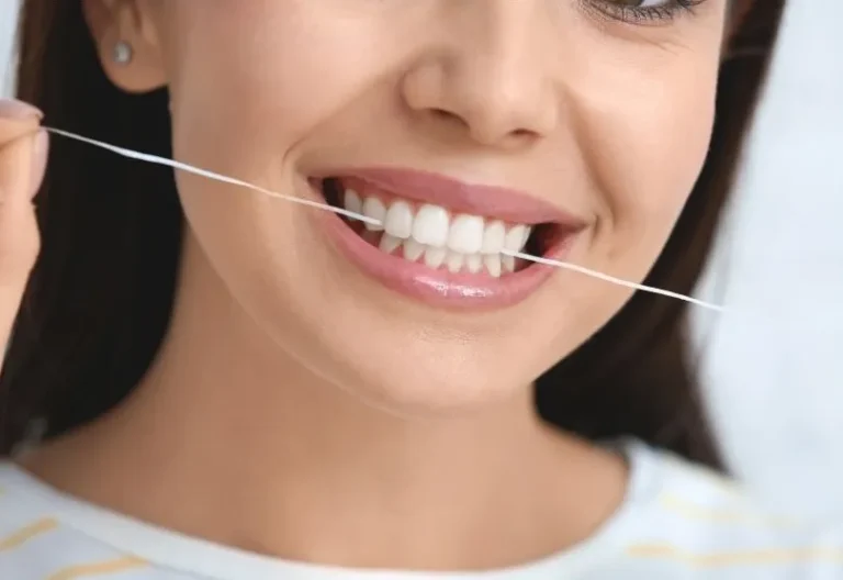 Dental floss cleaning teeth close-up in Wethersfield CT