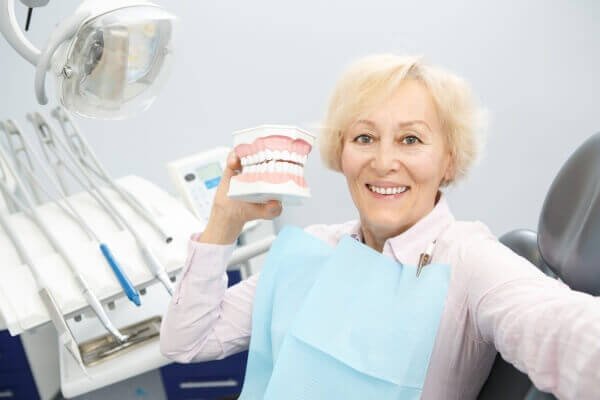 Senior woman with dentures smiling